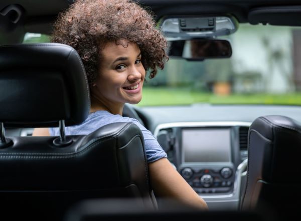 Driver in a car looking back